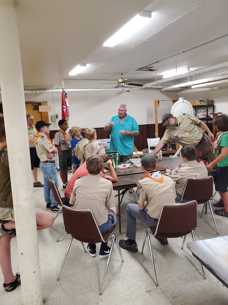 Scouts learning how to tie fishing lures onto rods