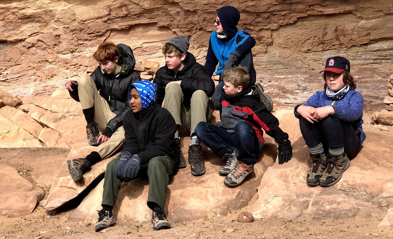 Kids sitting on rock